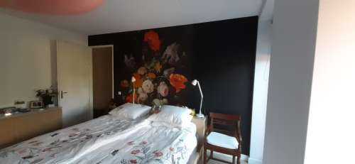 Stilleben med blomster og en klokke