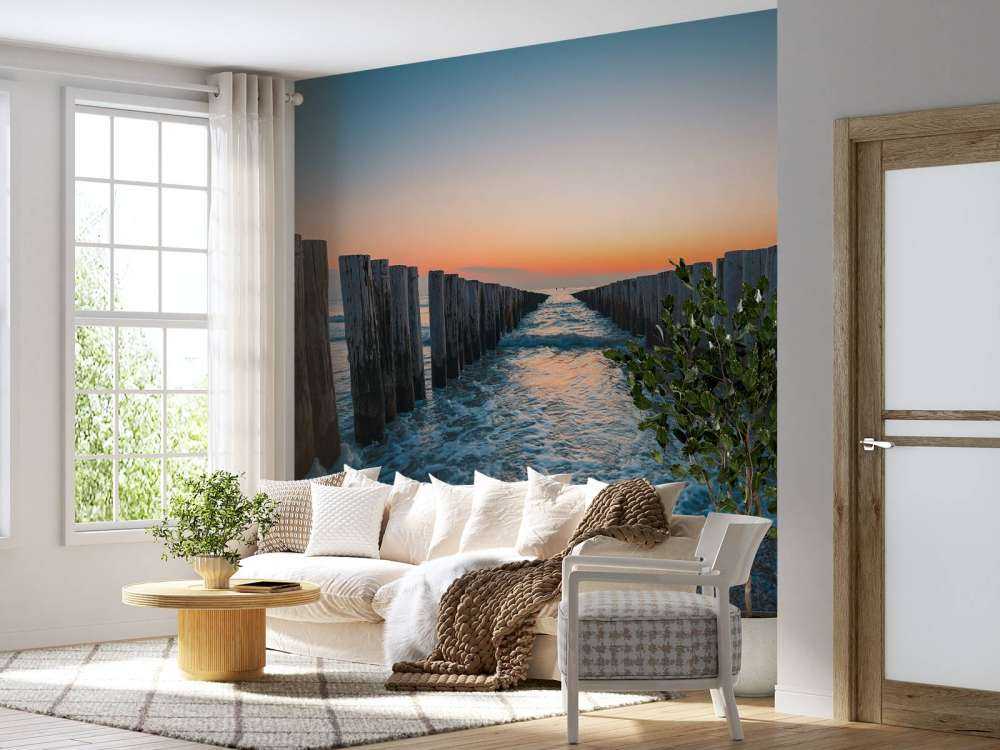 Bølgebrydere ved solnedgang