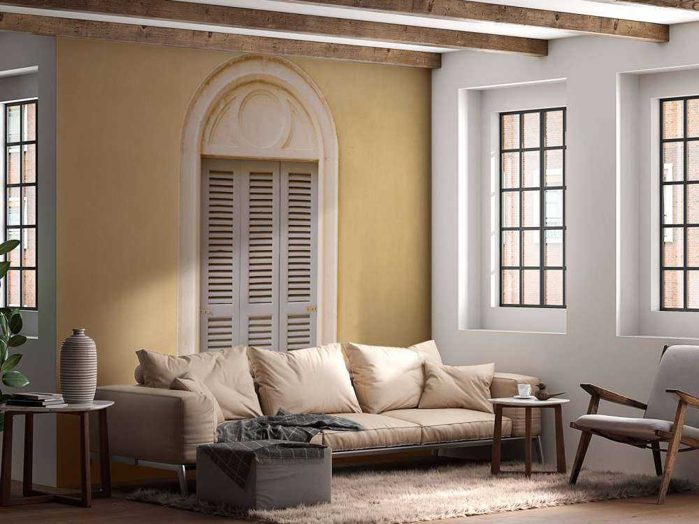 Vindue med træskodder på gul væg