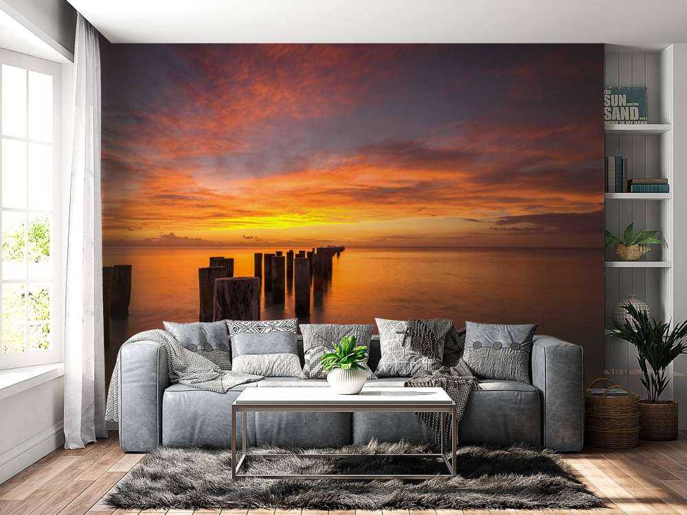 Bølgebrydere ved solopgang